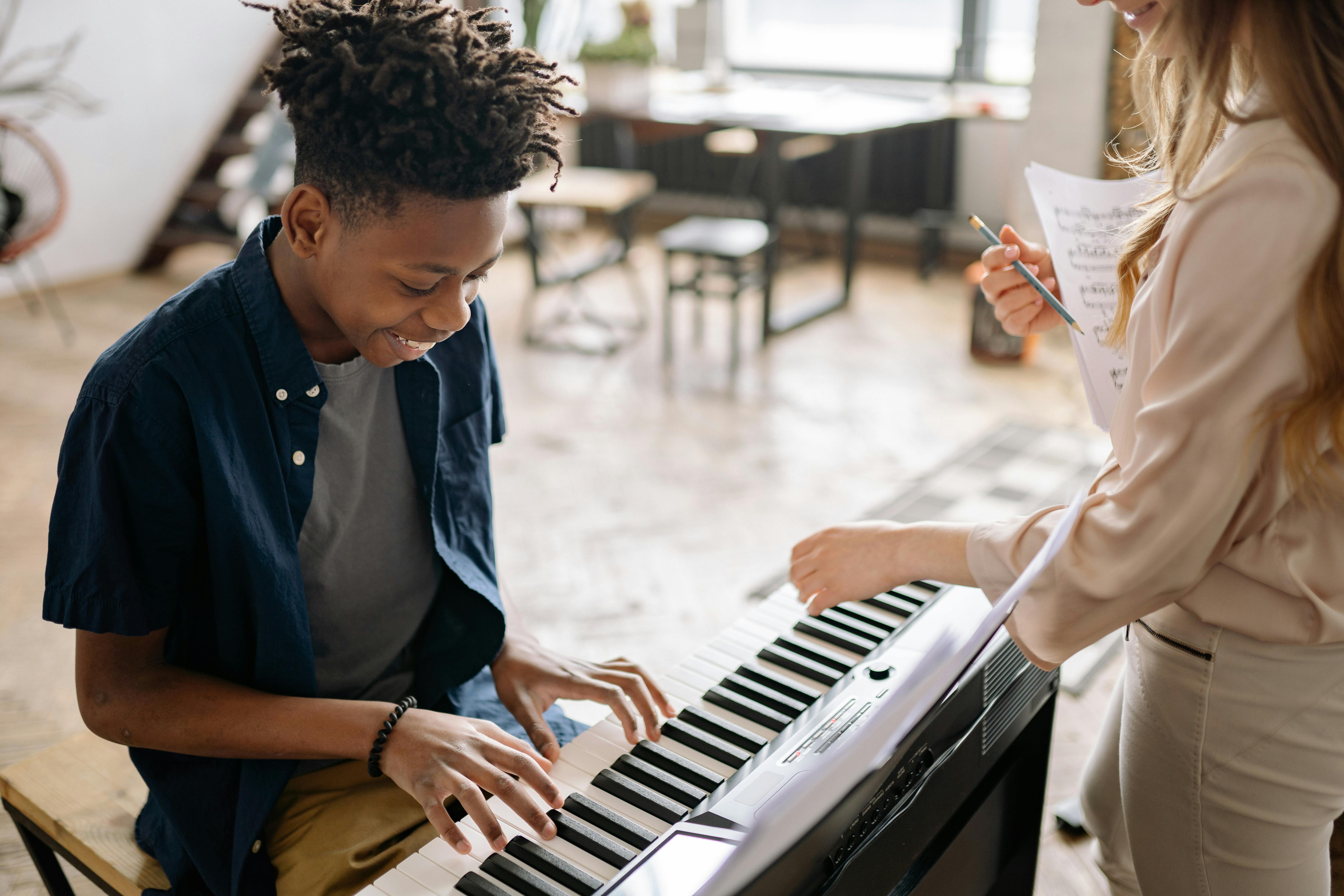A boy learning how to play piano